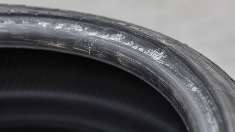 Close-up of a tire bead area showing mounting lubricant residue and scuff marks, signs a tire has been mounted before