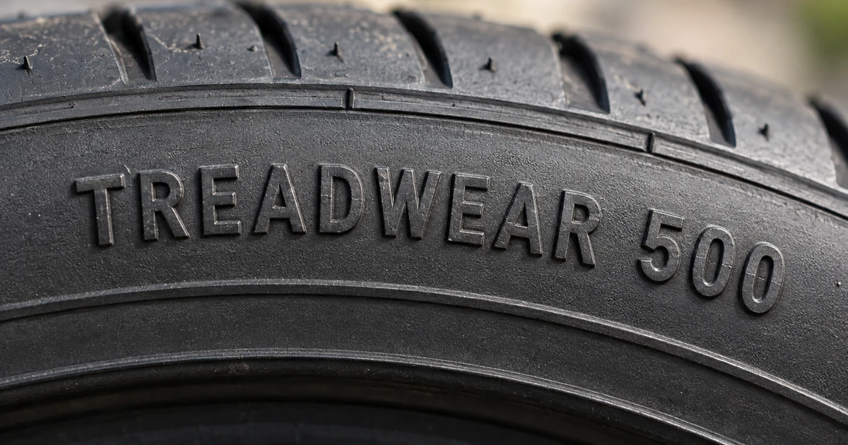 UTQG treadwear marking molded into a tire sidewall showing TREADWEAR followed by a number