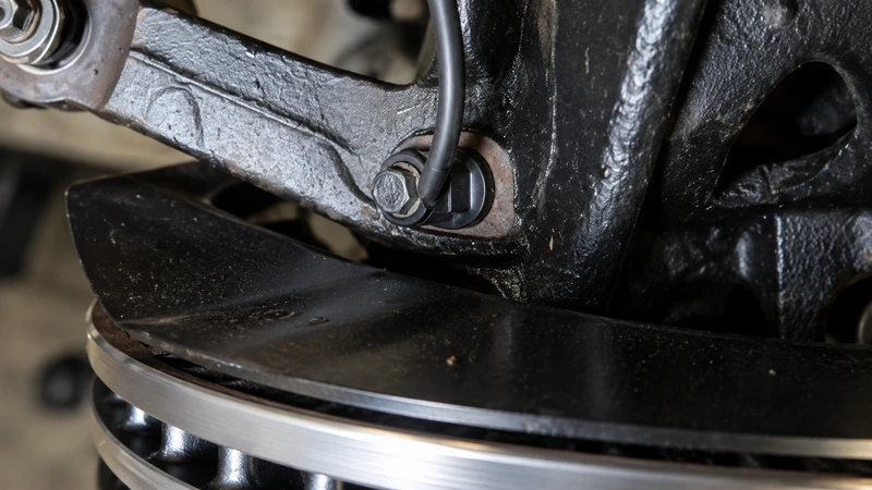 An ABS wheel speed sensor at the wheel hub — the hardware behind Honda's indirect TPMS